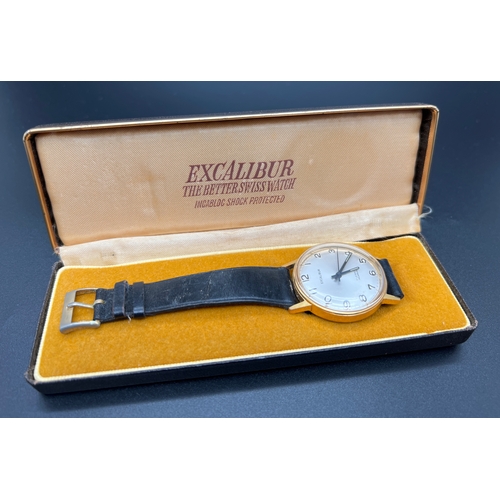 1143 - A vintage Excalibur men's wristwatch with black leather strap, gold plated case, brushed pale silver... 