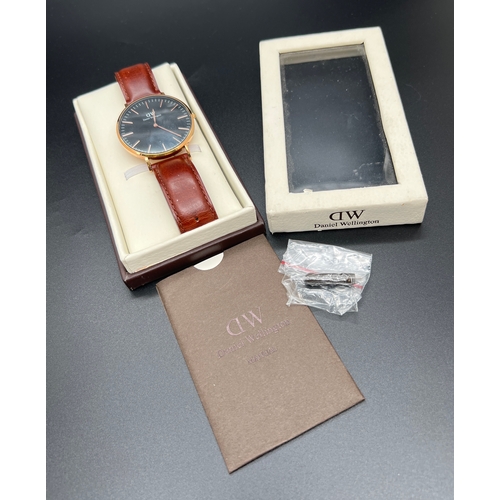 1144 - A Classic G40R01 men's wristwatch by Daniel Wellington. Brown leather strap with gold tone case and ... 