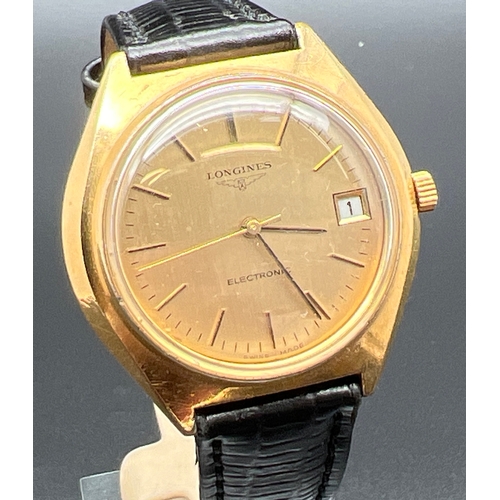 1149 - A classic style men's electronic wristwatch by Longines with black leather strap. Gold tone case and... 