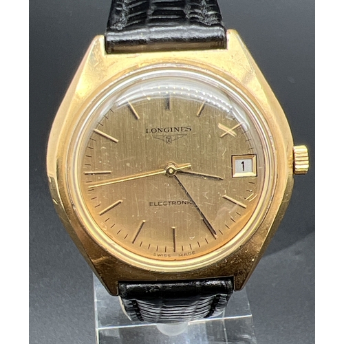 1149 - A classic style men's electronic wristwatch by Longines with black leather strap. Gold tone case and... 