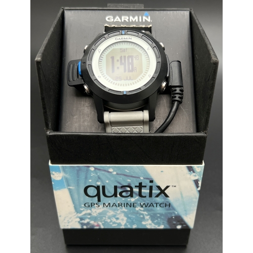 1150 - A boxed Garmin Quatix GPS Marine watch with leads. Grey silicone strap with black case and digital d... 