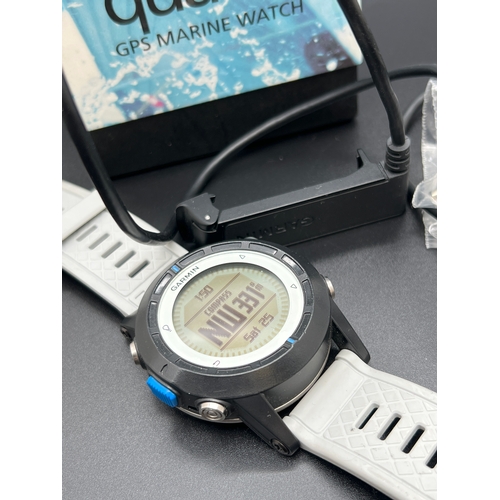 1150 - A boxed Garmin Quatix GPS Marine watch with leads. Grey silicone strap with black case and digital d... 