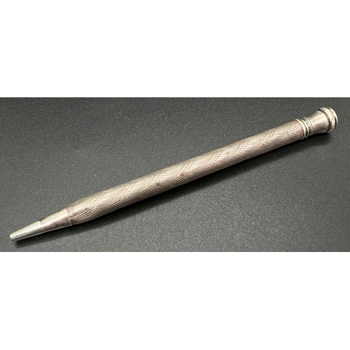 1169 - A vintage sterling silver propelling pencil with engine turned decoration to main body. Approx. 9cm ... 