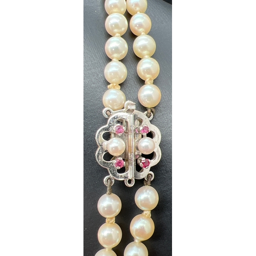 1047 - A vintage cream cultured pearl double row necklace with 14ct white gold clasp set with pearls and ru... 