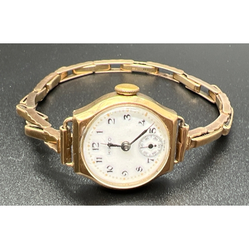 1155 - A vintage ladies 9ct gold cocktail watch with expanding bracelet strap by Hirco. White enameled face... 