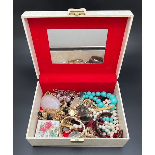 1061 - A large vintage cream coloured jewellery box and contents to include gold tone and beaded jewellery ... 