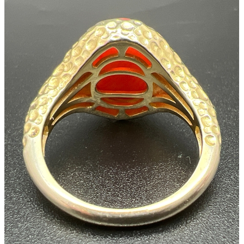 1066 - A vintage 9ct gold on silver signet style ring set with large oval cabochon of coral. Shoulders and ... 