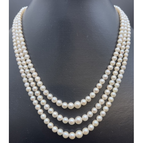 1067 - A vintage 3 row string of graduated real cultured pearls with marcasite set fish hook clasp. In a pe... 