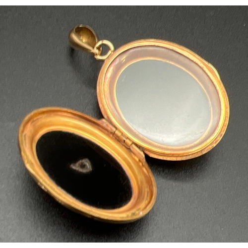 1003 - An antique Victorian 24ct gold locket set with onyx panels back & front and ornate seed pearl centre... 
