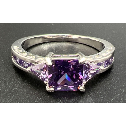 1070 - A modern white metal cocktail ring of Art Deco design, set with purple coloured stones. Ring size U.