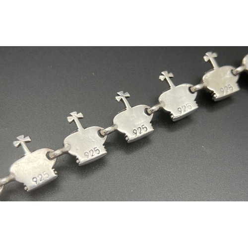 1073 - A heavy 925 sterling silver crown and cross design panel bracelet in the style of Vivienne Westwood.... 