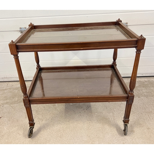 1403 - A vintage dark wood tea trolley with turned legs and glass inserts to shelves.