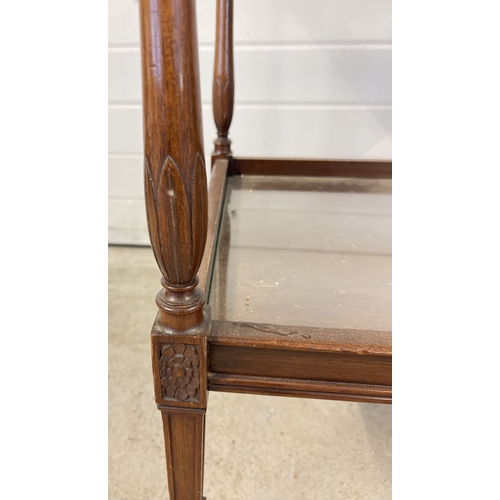 1403 - A vintage dark wood tea trolley with turned legs and glass inserts to shelves.