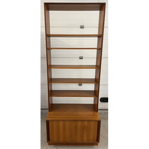 1408 - A mid century G Plan wall unit with sliding door cupboard to base and 5 shelves. 3 fixed shelves and... 