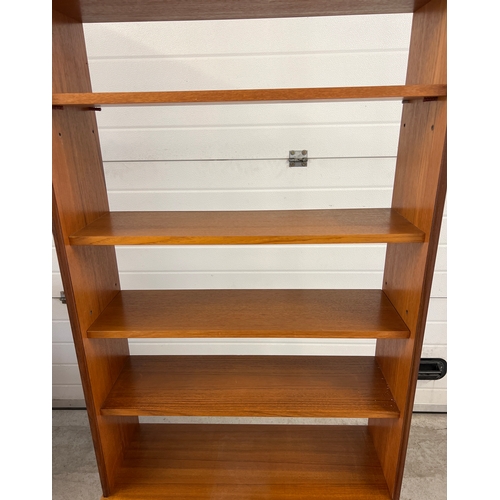 1408 - A mid century G Plan wall unit with sliding door cupboard to base and 5 shelves. 3 fixed shelves and... 