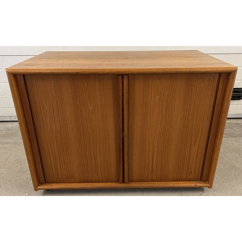 1409 - A mid century teak low cupboard with sliding doors and interior shelf. Approx. 72cm tall x 92cm long... 