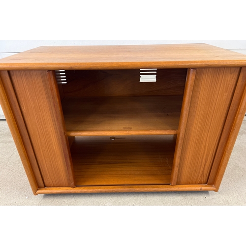 1409 - A mid century teak low cupboard with sliding doors and interior shelf. Approx. 72cm tall x 92cm long... 