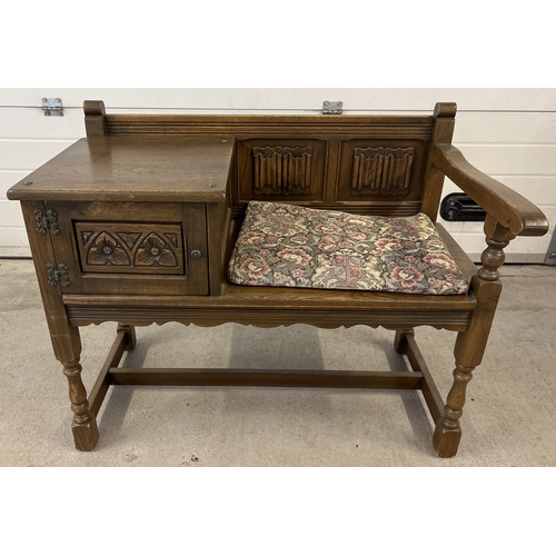 1410 - A vintage Old Charm hall seat with built in cupboard, decorated with linen fold carved detail to sea... 