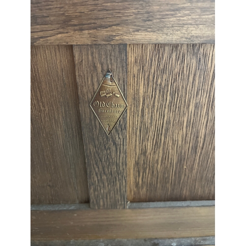 1410 - A vintage Old Charm hall seat with built in cupboard, decorated with linen fold carved detail to sea... 