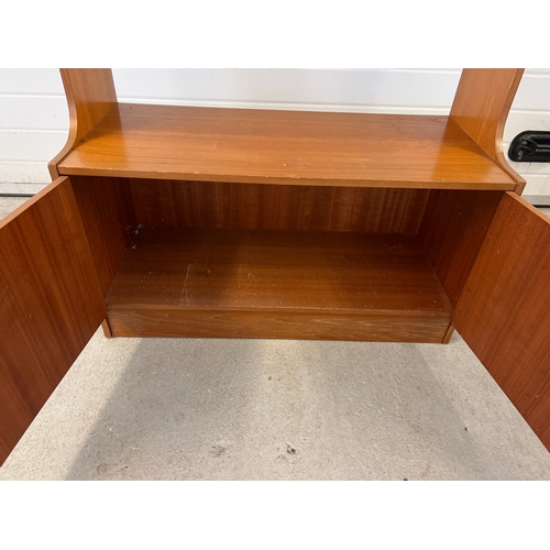 1412 - A mid century teak wall unit with 2 door cupboard, possibly Stag. With wooden knob handles and 3 fix... 