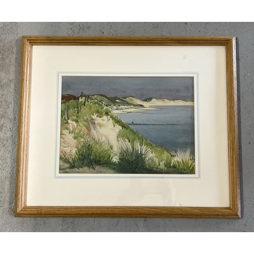 1386 - A framed and glazed watercolour of a beach and cliff top scene 