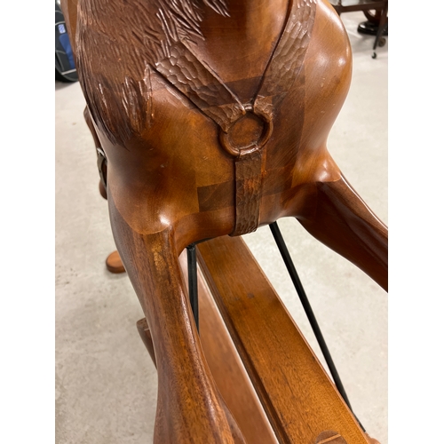 A vintage hand carved hardwood carousel style glider rocking horse. Saddle and bridle carved in wood