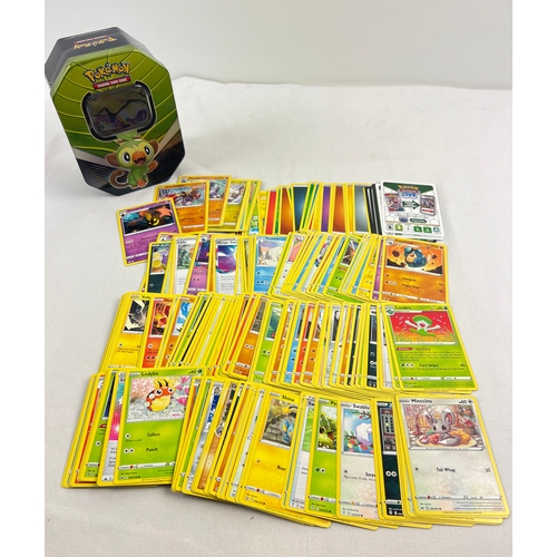 17 - 226 assorted Pokemon cards in an 2020 Pokemon from Galar Rillaboom V octagonal shaped tin. Cards com... 