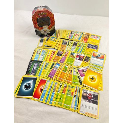 23 - 225 assorted Pokemon cards in a 2020 Pokemon V Galar Partners Cinderace V octagonal shaped tin. Card... 