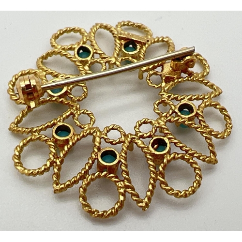 133 - A 18ct gold open work circular brooch set with 8 small round turquoise cabochons. Secure pin to back... 
