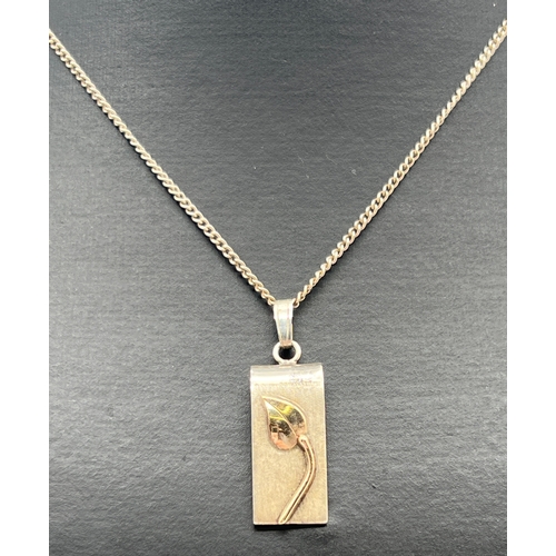 1030 - A modern design white metal rectangular pendant with 9ct gold leaf detail to front, on an 18