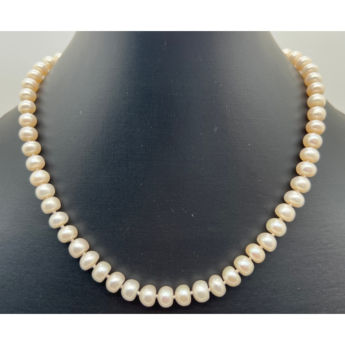 1033 - A 16 inch freshwater pearl necklace with silver lobster style clasp. Silver mark to clasp.