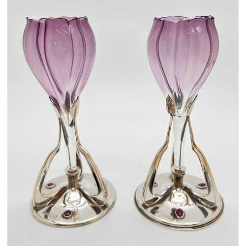 1221 - A pair of Art Nouveau silver & glass flower vases, each set with 3 garnet cabochons to base. Hallmar...