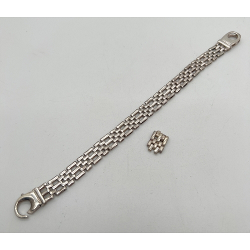 1036 - A heavy white metal gate link bracelet with large lobster style clasp and extra link. Indistinct mar... 