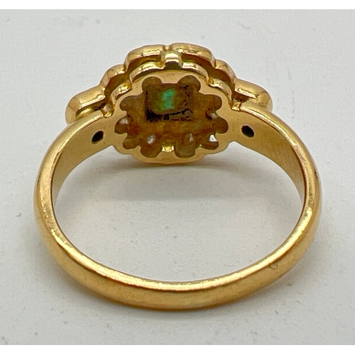 1039 - An 18ct gold diamond and emerald dress ring. Central square cut emerald surrounded by 8 round cut di... 