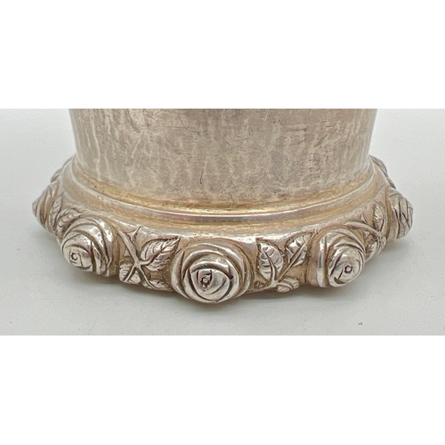 1223 - An Omar Ramsden Arts & Crafts silver beaker of hammered conical form with rose design rim to base. F... 