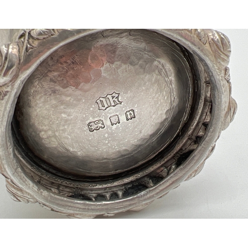 1223 - An Omar Ramsden Arts & Crafts silver beaker of hammered conical form with rose design rim to base. F... 