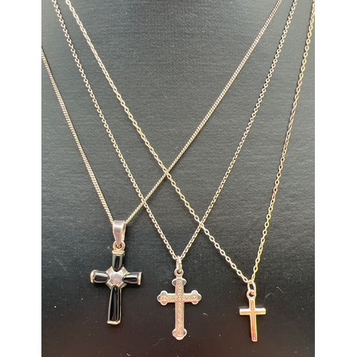 1054 - 3 silver necklaces each with a small cross pendant. A plain cross on a fine belcher chain, a cross w... 