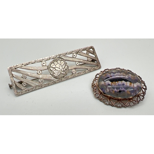 1057 - 2 vintage silver brooches. An oval brooch with heart design pierced work mount set with Blue John, t... 
