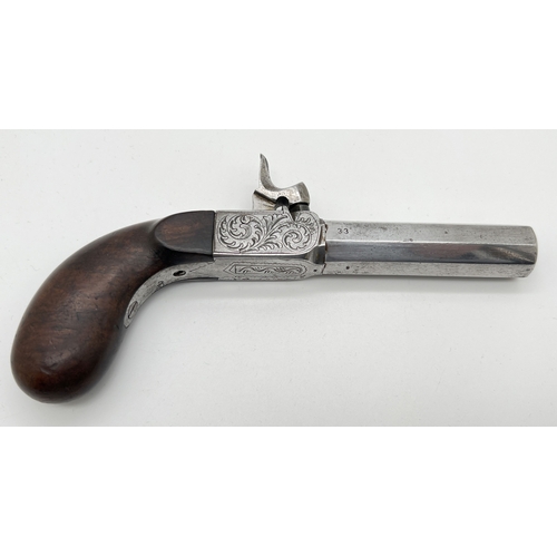 1283 - An antique percussion pocket pistol with wooden grip and engraved hardware. Barrel stamped 33, under... 