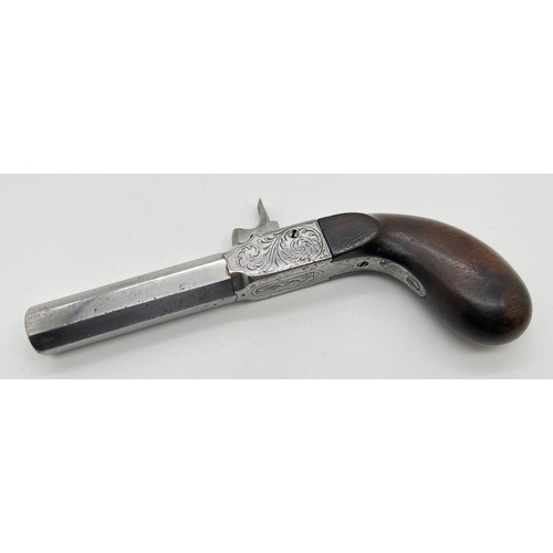 1283 - An antique percussion pocket pistol with wooden grip and engraved hardware. Barrel stamped 33, under... 
