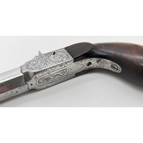 1283 - An antique percussion pocket pistol with wooden grip and engraved hardware. Barrel stamped 33, under... 
