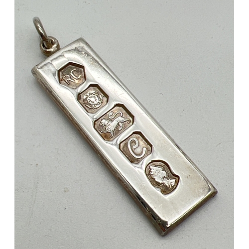 3 - A vintage silver ingot pendant with hanging bale. Full hallmarks to front for Sheffield 1977. Approx... 
