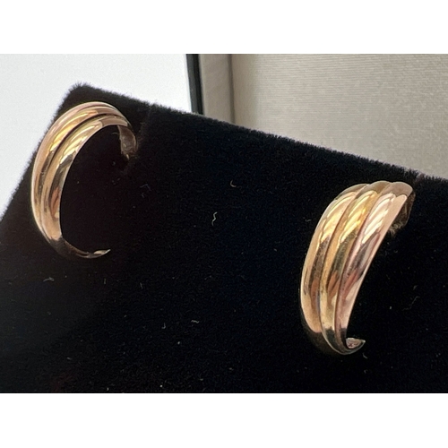 17 - 2 pairs of gold earrings. A pair of knot shaped studs with hallmarks to posts and a pair of 3 strand... 