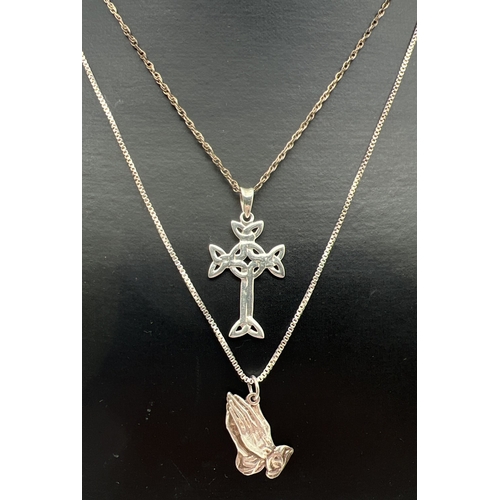 29 - 2 religious themed silver necklaces. A Celtic design cross shaped pendant on an 18
