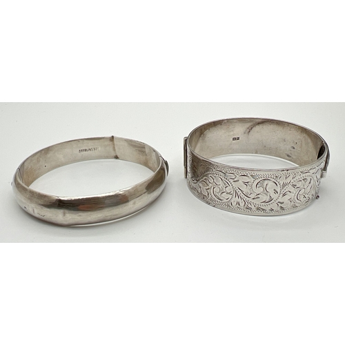 30 - 2 vintage silver bangles. A plain bangle with push clasp, marked Sterling, together with a 2.25cm wi... 