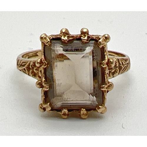 42 - A vintage 9ct gold, claw set smoked quartz dress ring. Central emerald cut smoked quartz in decorati... 