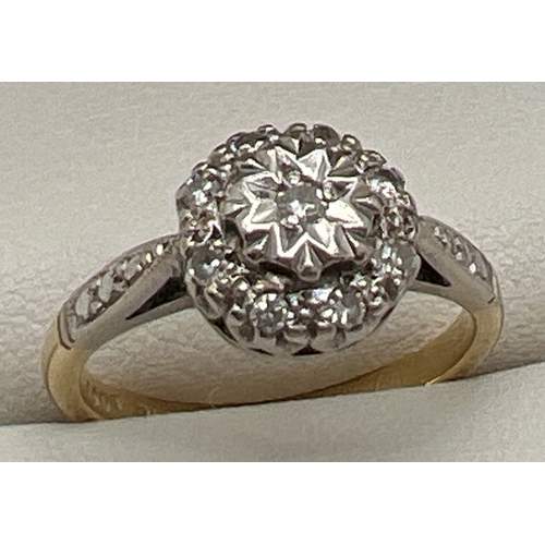 58 - An 18ct gold and platinum diamond cluster ring. Small round cut central diamond surrounded by 8 smal... 