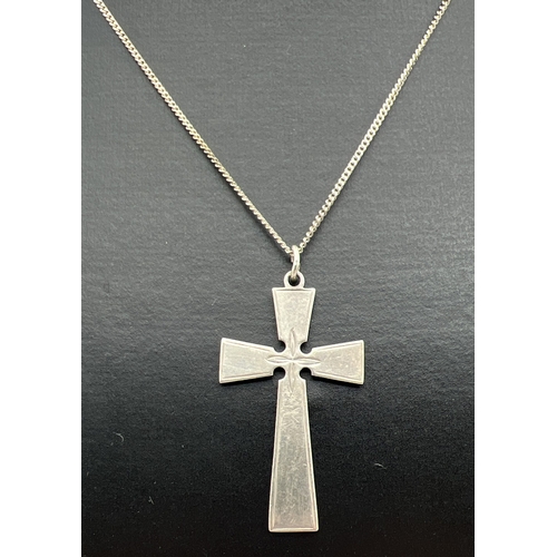 59 - A decorative silver cross shaped pendant on an 18