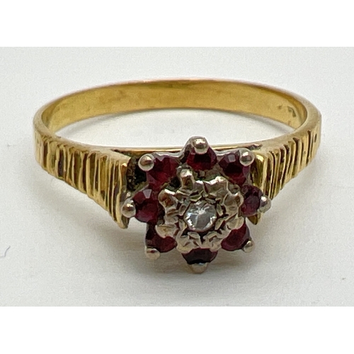 62 - A vintage 9ct gold, garnet and diamond dress ring. Small central round cut diamond surrounded by 8 s... 