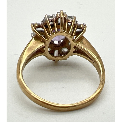 64 - A 9ct gold, amethyst and clear stone decorative dress ring. A central oval cut amethyst surrounded b... 